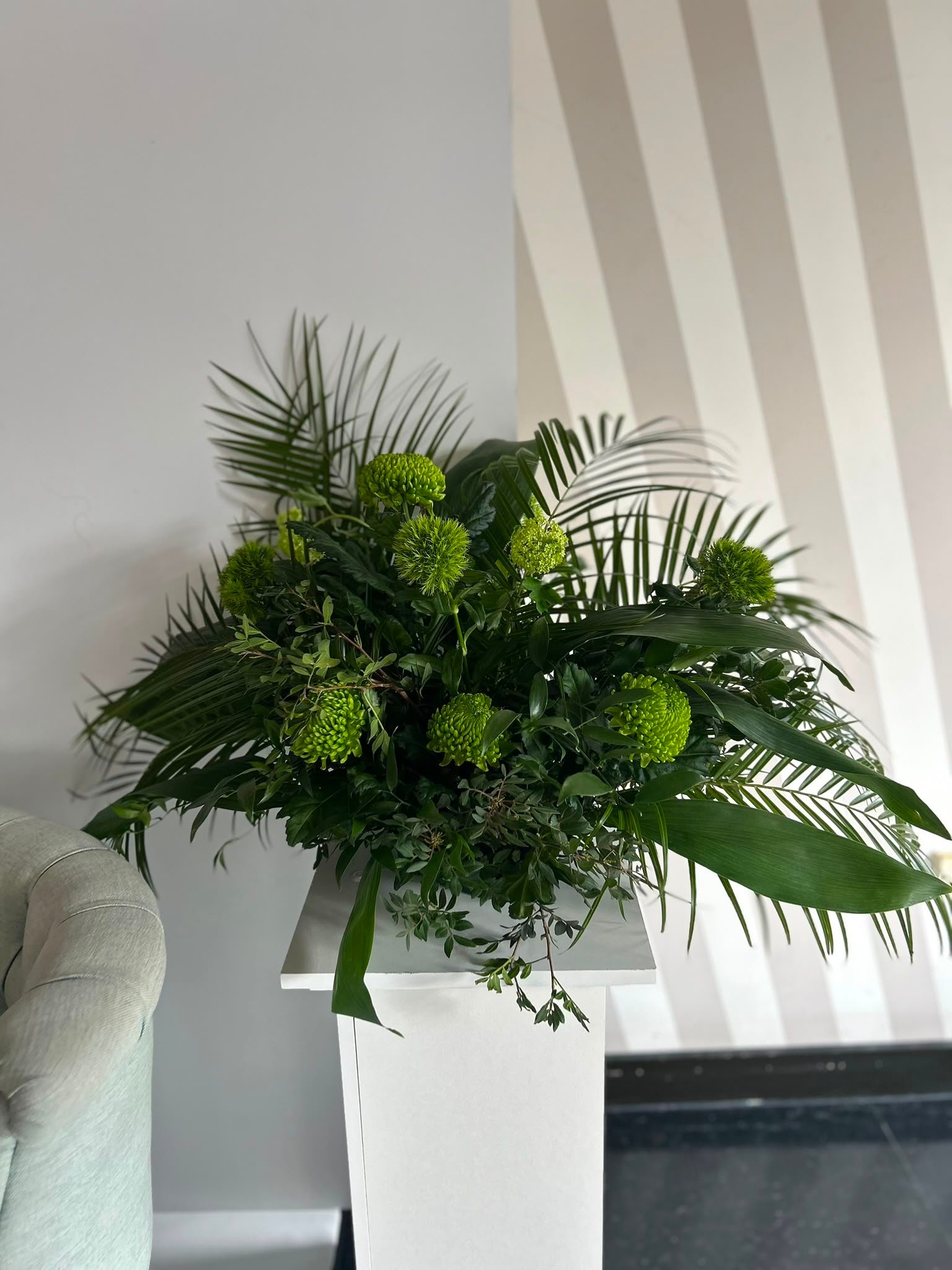 Early floral styling work, structured green arrangement