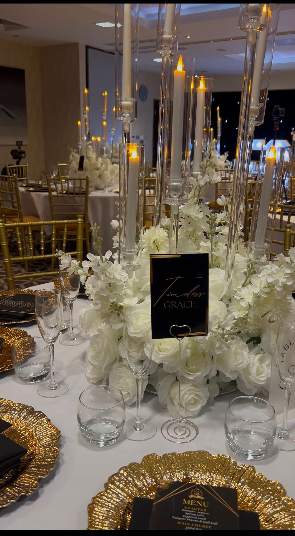 Fine dining tablescape with candlesticks and white roses